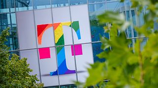 Deutsche Telekom logo in rainbow colors on the facade of an office building 