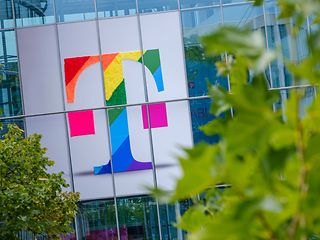 Deutsche Telekom logo in rainbow colors on the facade of an office building 