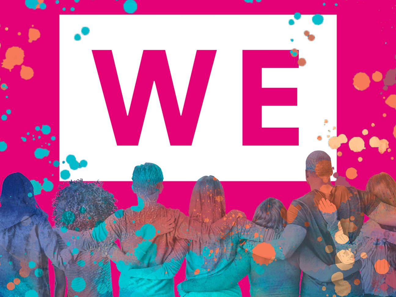 People celebrate while standing in front of a banner that reads We