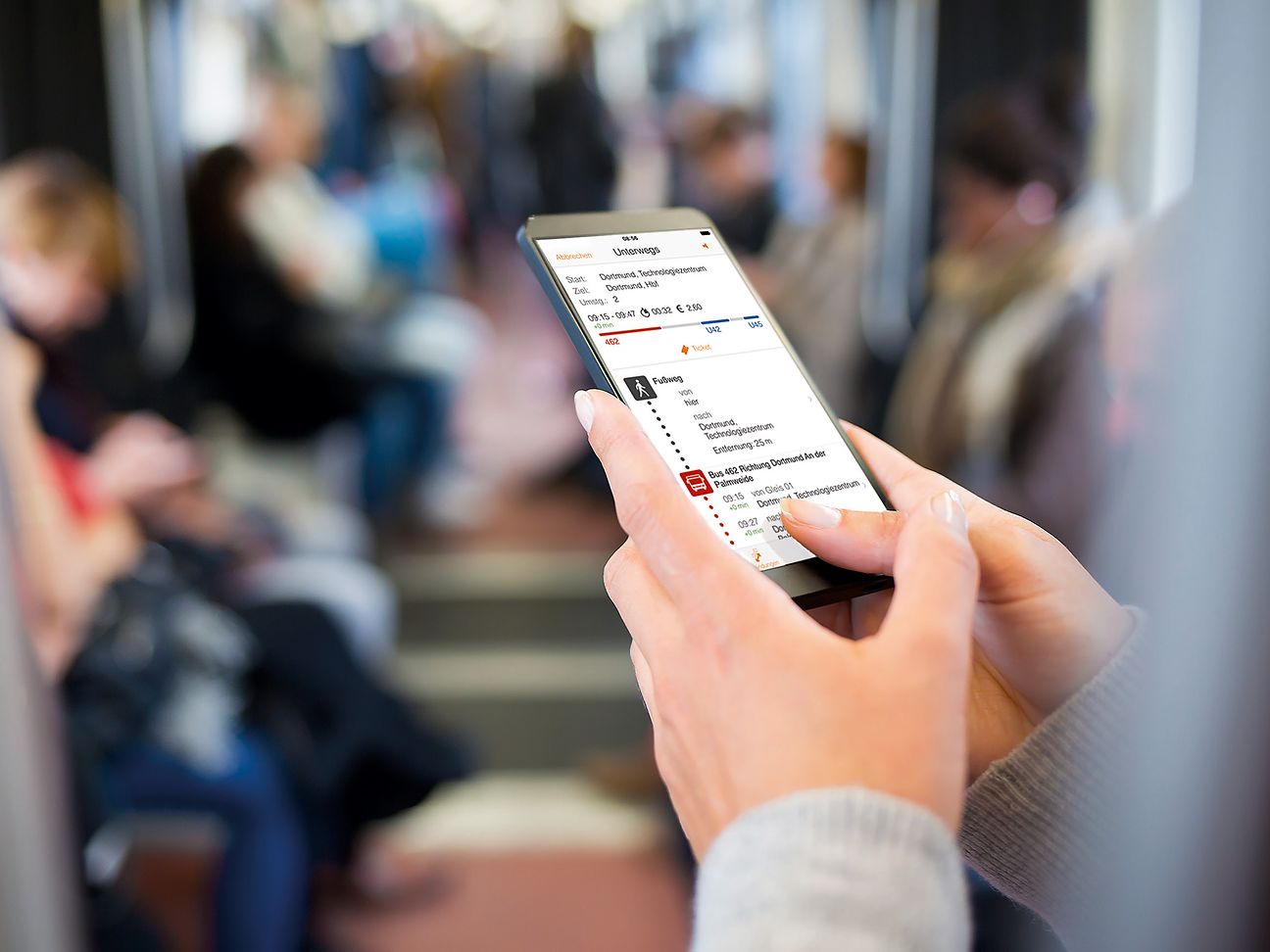 Passenger looks at smart phone.