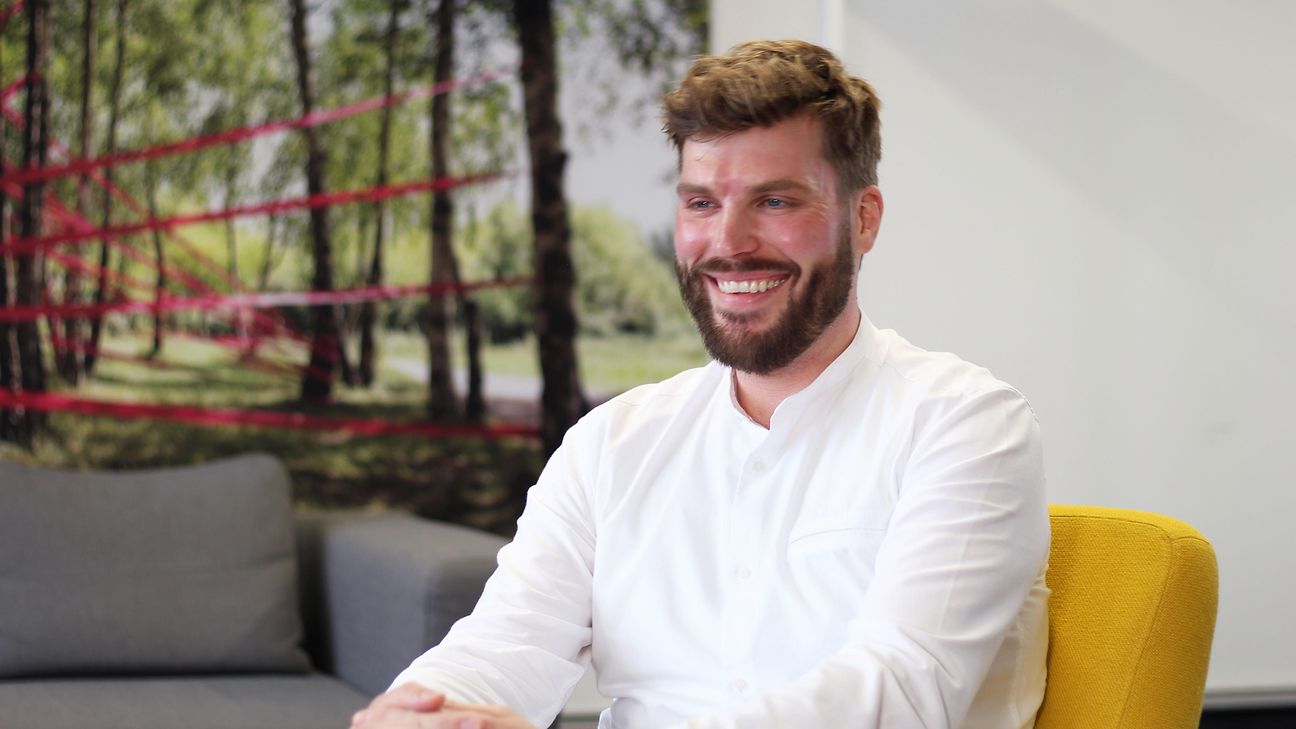 An employee smiles at the camera