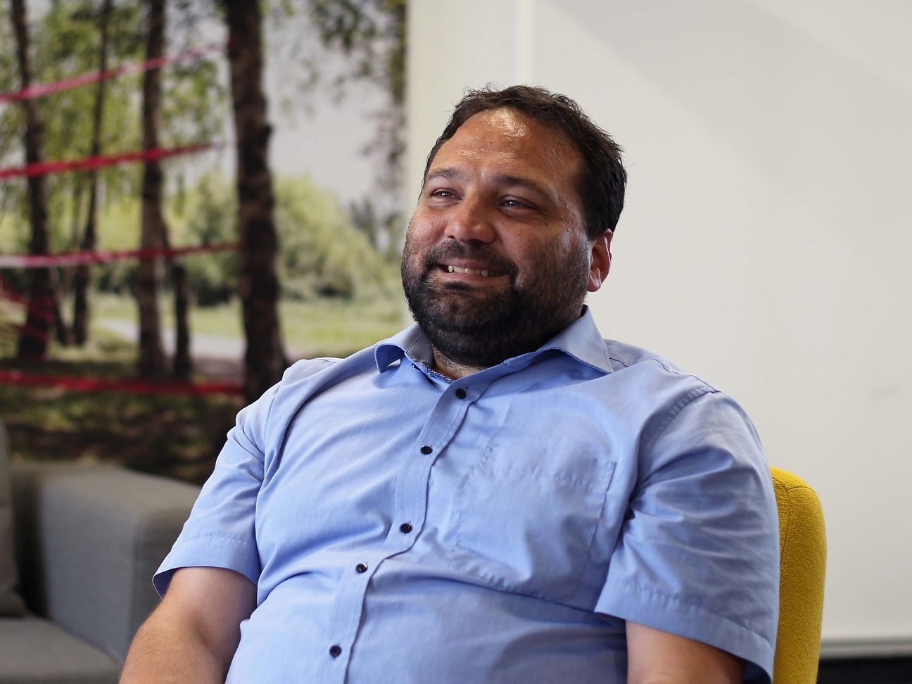 An employee smiles at the camera