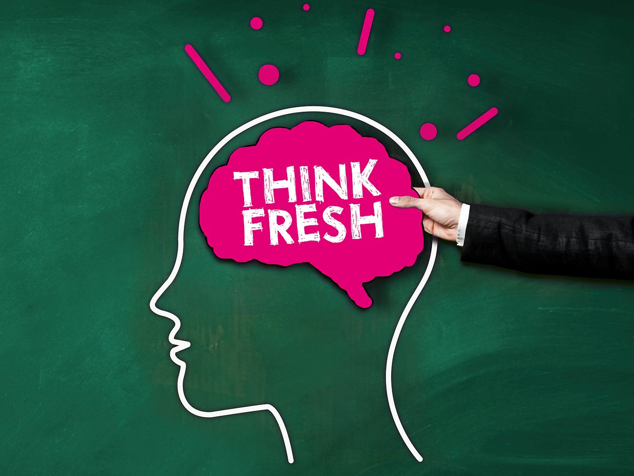A male hand holds a sign as a brain with the inscription Think fresh.