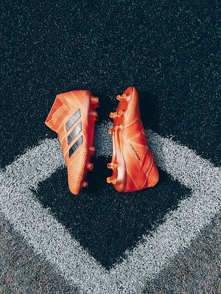 A pair of orange football boots