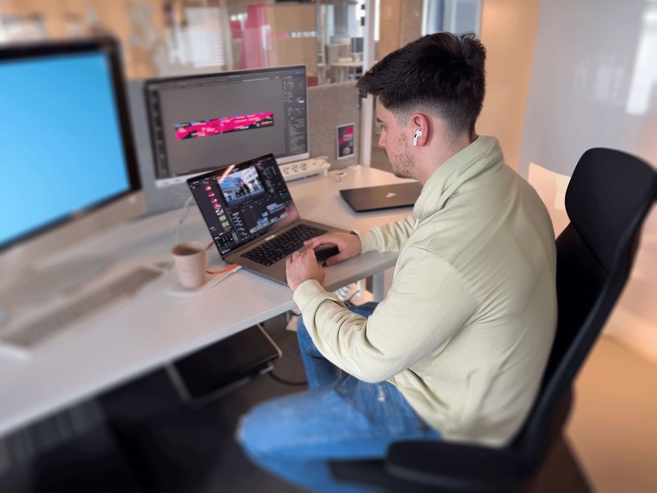 Nick Schneider (Corporate Communications Trainee) prepares content for social media on his laptop.