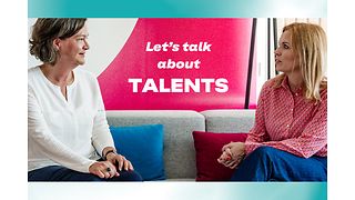 Image of two female managers sitting on a sofa and discussing.