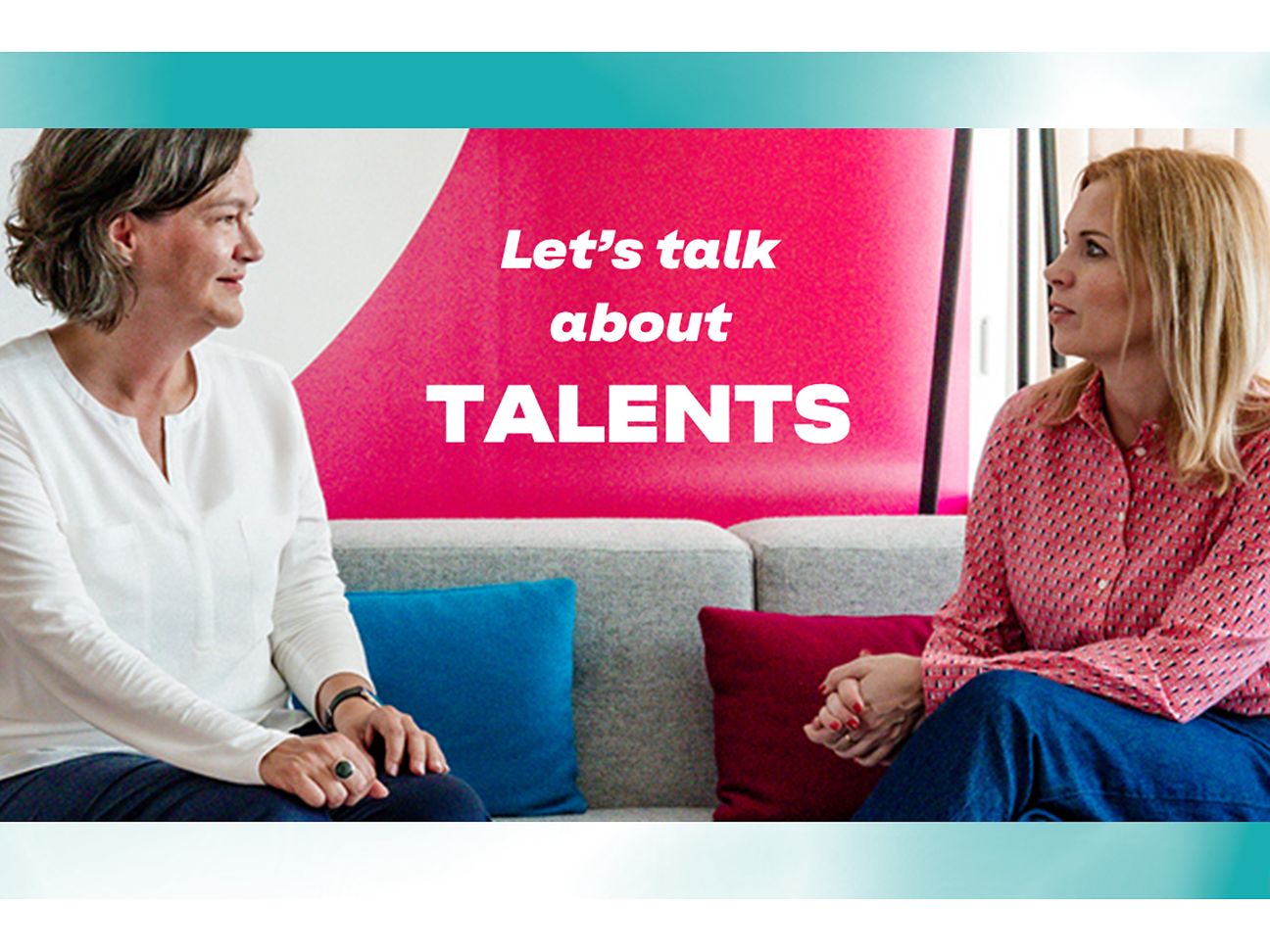 Image of two female managers sitting on a sofa and discussing.