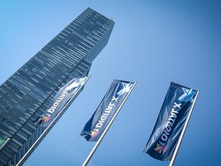 Flag with "Digital X" against the sky.