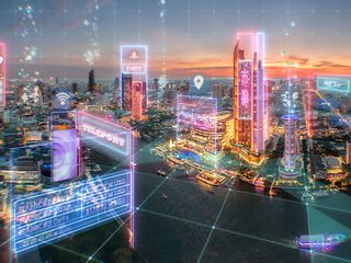 A futuristic city view at sunset with digital holograms such as “event”, “teleport”, and “marketplace”