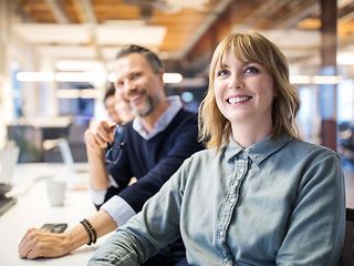 Two people sitting and discussing at a desk