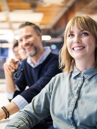 Two people sitting and discussing at a desk