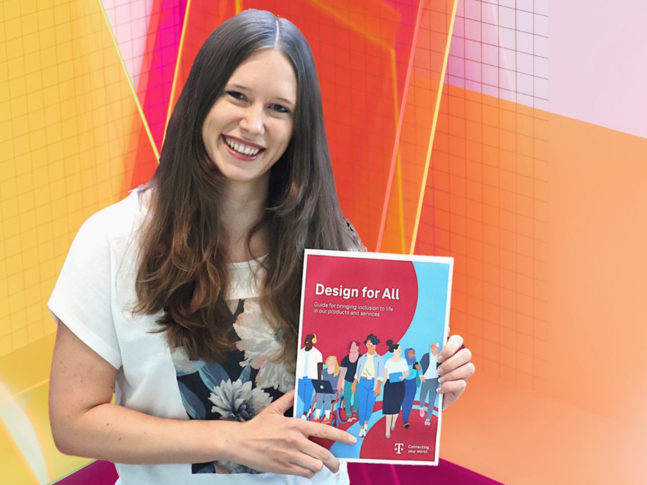Annika Theiß holds the „Design for All Guide“ in her hands.