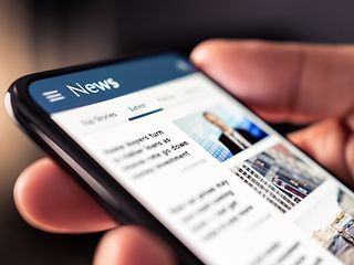 Smartphone displaying news.