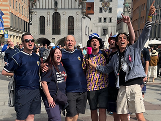 Eine singende Gruppe Fussballfans auf einem Marktplatz