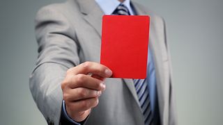 Man showing a read card.