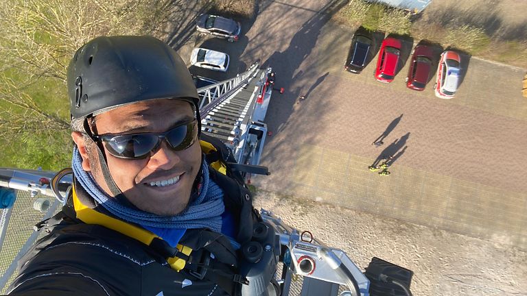 Stefan Keller works from the bucket of a turntable ladder.
